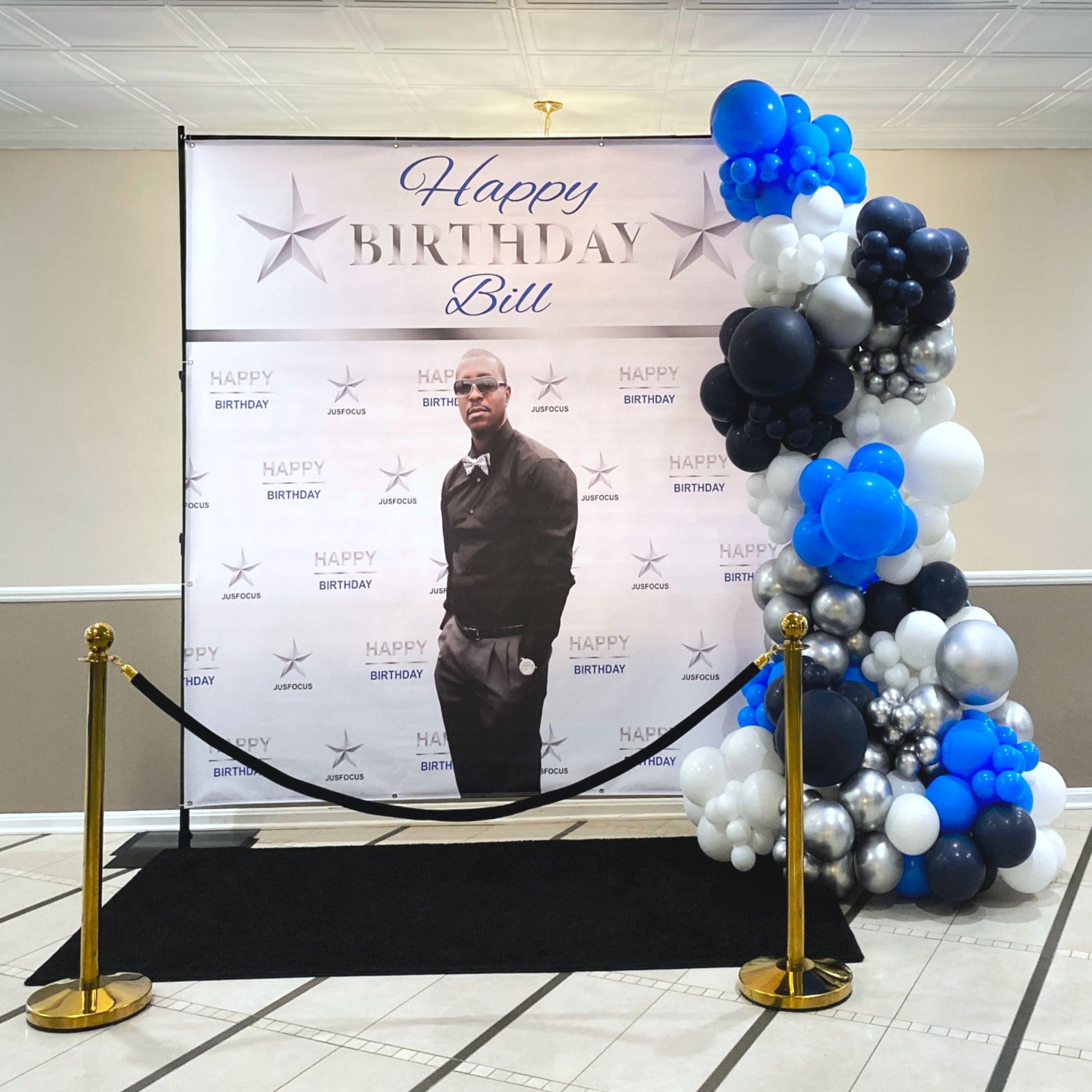 Balloon garland and custom backdrop with the colors navy blue, royal blue, silver and white