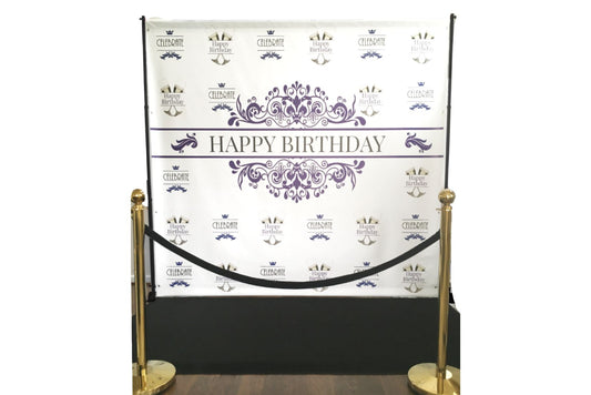 Purple and black happy birthday banner. The step and repeat set is for rent with banner, poles, black carpet, brass stanchions and black velvet rope.