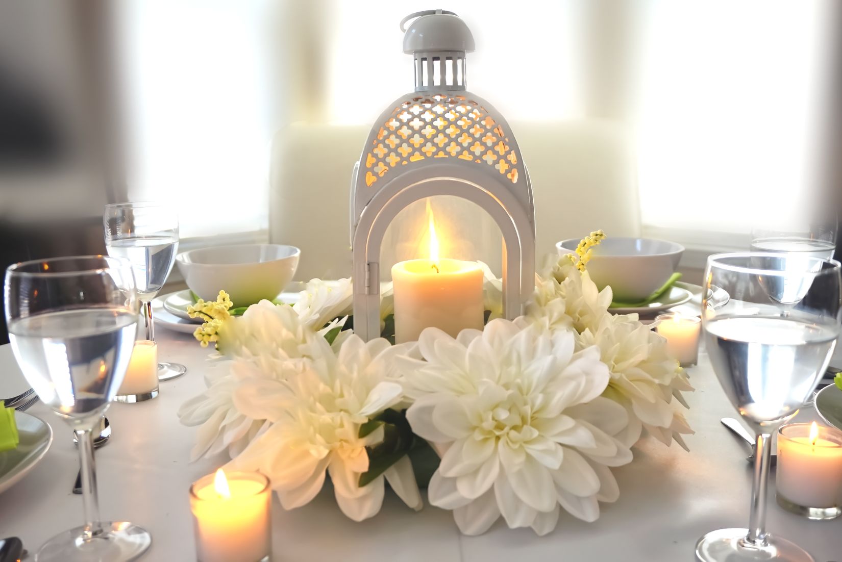 White table lantern with candle and floral ring. Available to rent in PG County Maryland