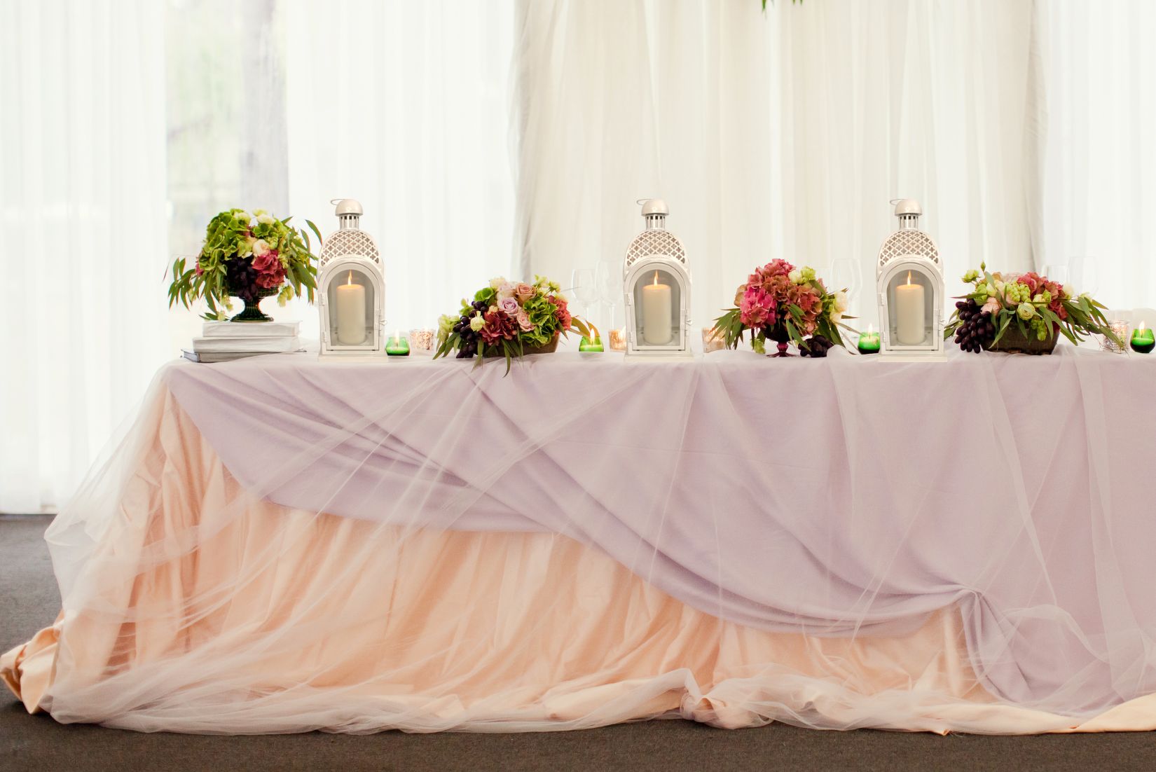 Dais table with lantern and floral decor.
